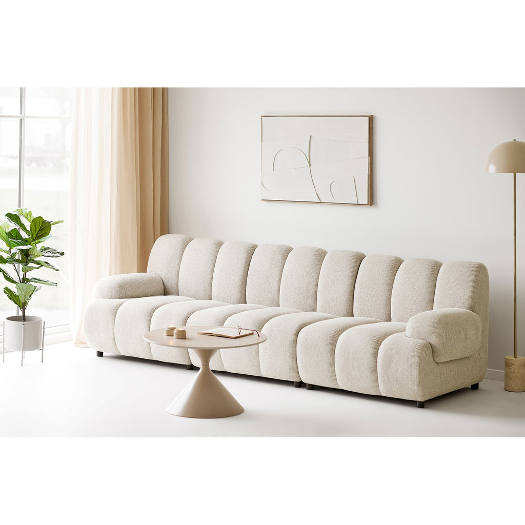 Canapé modulaire crème en peluche avec coussins ronds segmentés et design minimaliste moderne