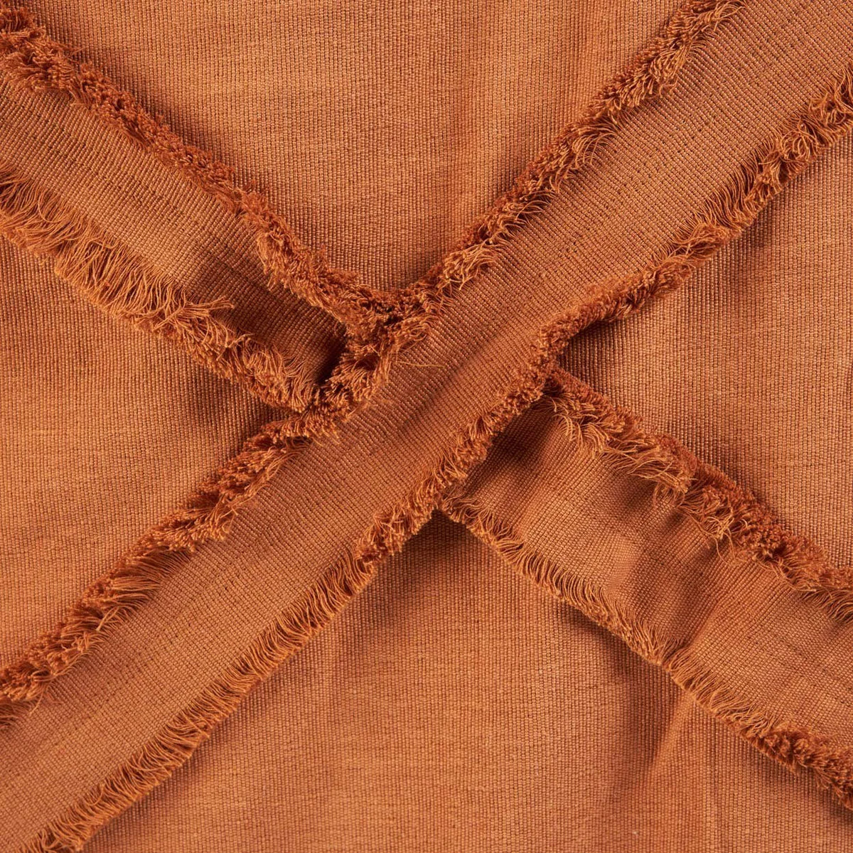 Couvre-lit en coton terracotta avec motifs en losanges et franges macramé
