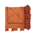 Plaid en coton terracotta avec losanges, franges macramé, plié, décoration chaleureuse