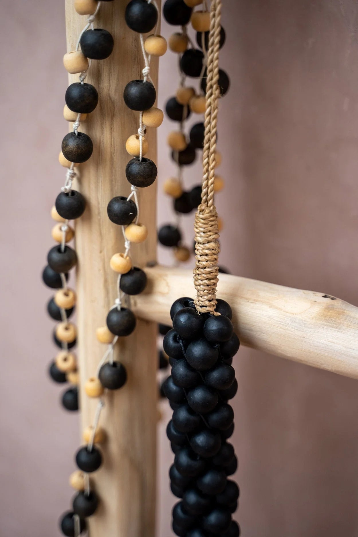 Guirlande murale en perles de bois noir mat et naturel avec accents bois et suspension corde dorée
