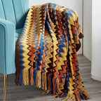 Couverture à franges en zigzag coloré Plaid Chevron sur une chaise, moments cocooning
