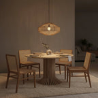 Lampe pendentif en rotin tressé géométrique sur table ronde en teck recyclé Ø120 cm